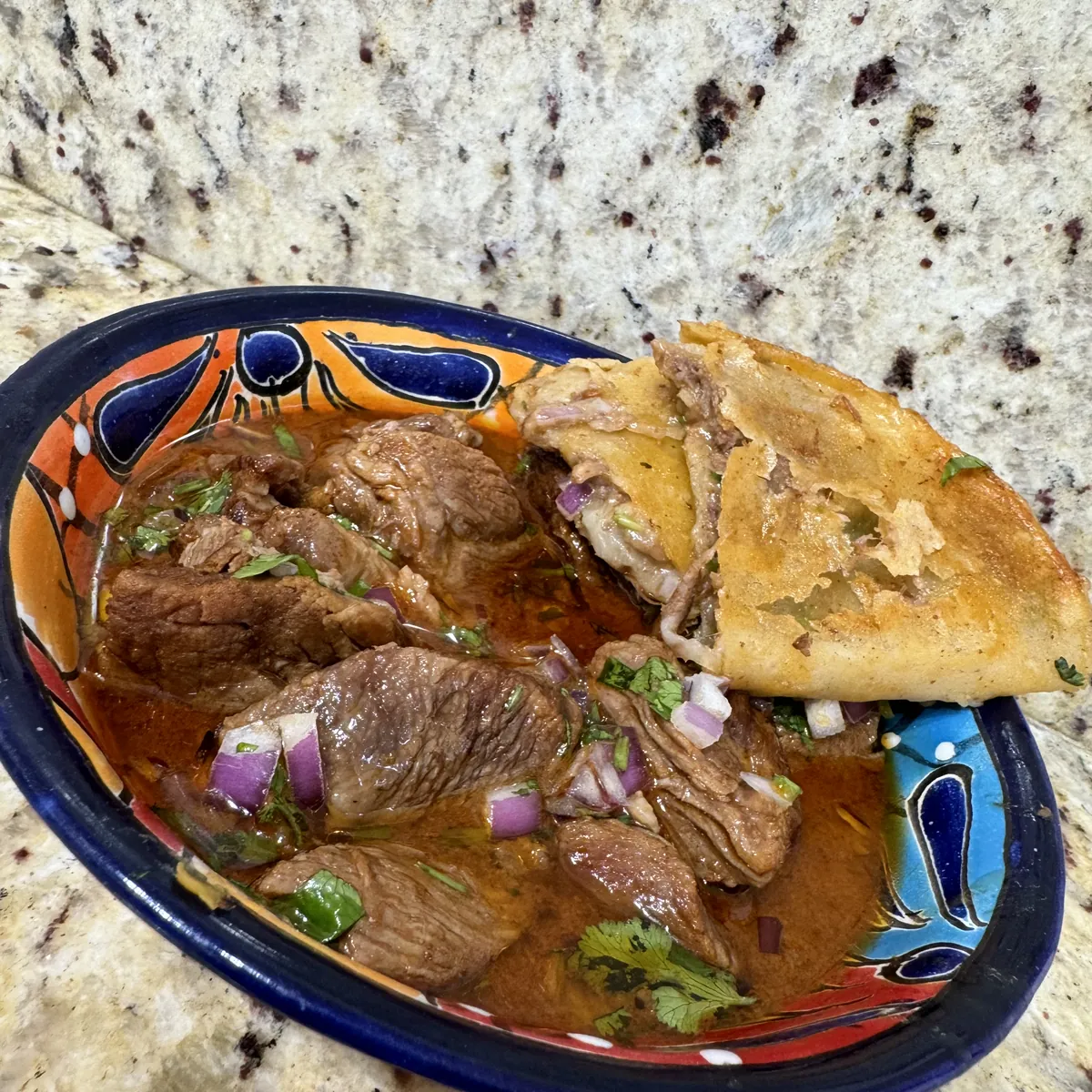 Birria with consomé and a quesataco