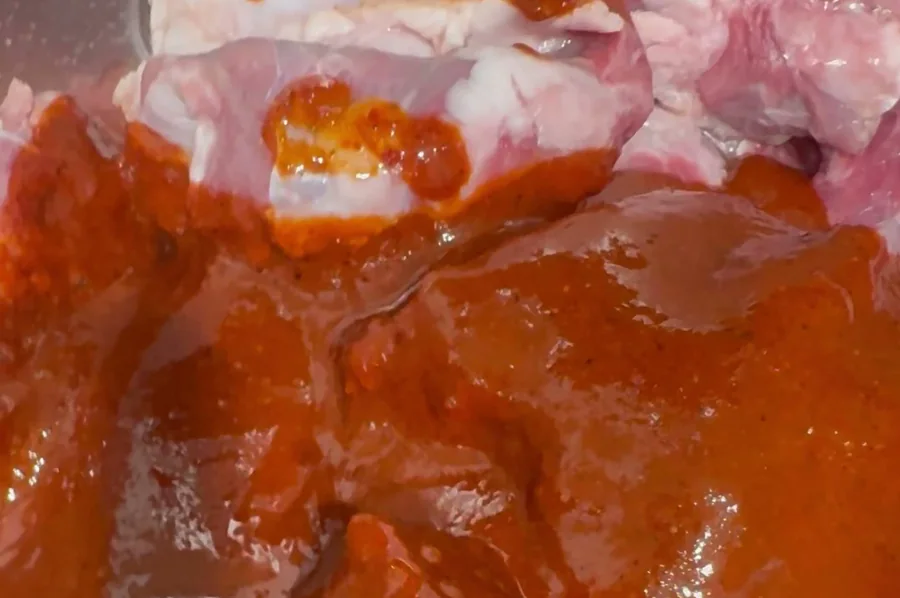 Frausto's birria sauce over beef in the pot